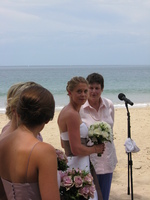 Hannah, in her bridal gown, looks over her shoulder toward her bridesmaids.