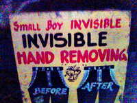 A painted sign 'Small Boy INVISIBLE' 'INVISIBLE HAND REMOVING'.