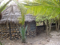 A small thatched stone house.