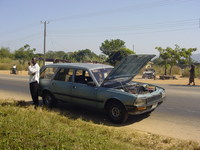 Car at the side of the road with smoke coming off the engine