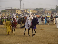 A group of men on horses, with a sign showing their district