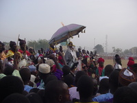 The Emir on his horse, under a parasol