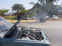 Smoke coming off the engine of a car