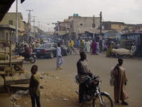 Street scene, pedestrians, cars and motorbikes everywhere