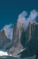 Picture of the Torres del Paine (Chile) with a column of cloud up the side of one of the towers