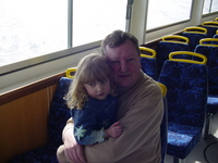 Dad holding Eve inside the cabin of a ferry