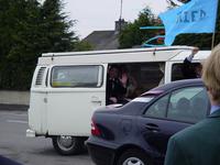 Andy and Therese leaving in a white VW camper with a 'just married' flag