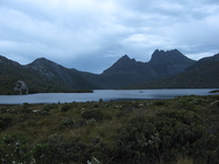 Craggy mountains rise behind a lake.