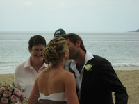 Hannah and Lee kiss in front of the wedding celebrant.