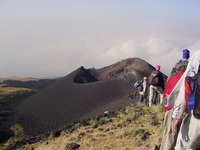 Cinder cone with group walking towards it