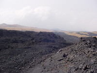 Lava flow spread across grassland