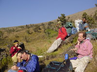 Part of the group sitting, resting and applying factor 25 on the mountainside