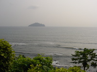 View across the sea to a small humpbacked island