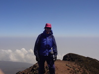 Me standing on top of a mountain, clouds in the background