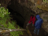 Otto and Indar stand at the entrance to a cave