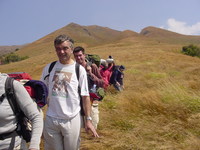 People walking down through high grass