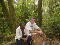 Pete sitting on a log beside one of the porters