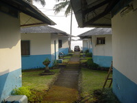 Rows of small blue and white huts with a path running up the middle