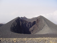 A cinder cone with a W-shaped gap in the side