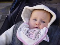Eve sitting outside in her pushchair
