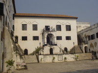 A castle courtyard, flights of stairs lead up to the entrance to the governor's residence.