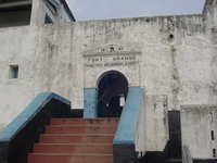 Red-painted stairs up to a gateway into a whitewashed fort.  '1640, FORT ORANGE, Ghana Ports and Harbours Authority' painted above the gateway.
