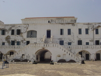 Whitewashed castle buildings surrounding a cobbled courtyard.