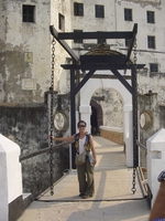 Marebec standing on a drawbridge in front of a whitewashed castle.