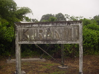A faded concrete sign with 'Kuranti' embossed into it.