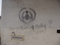 A graffitied UNHCR logo with 'Have you heard us today?' written underneath.