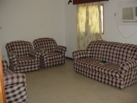 Picture of the living room, showing the chairs and sofa