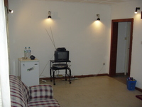 Picture of the living room, showing the TV and fridge
