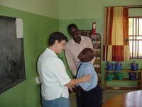 Sister Brenda with a child and teacher