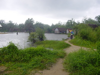 Small inlet with fisherman and isolated house