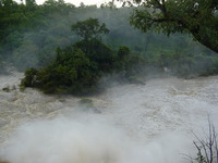 An island below the falls, shrouded in mist