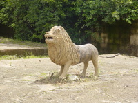 An ugly concrete statue of a lion.