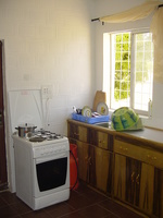 My kitchen, from the living room door. Kitchen with cooker, sink and cupboards