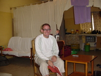 Paul sitting in his house, kitchen visible behind him