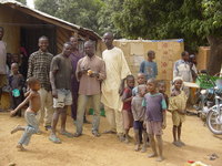 Men and children standing outside the village shop