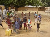 Children standing in a dusty village square