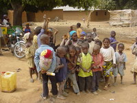 Children standing in a dusty village square