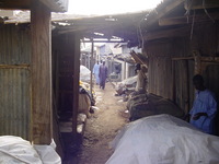 Looking up one of the alleys, corrugated metal shops to either side