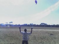 A boy flying a kite.