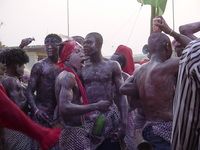 Group of dancers, some clutching bottles and cans