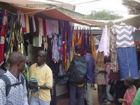 Dave and George negotiate with the owner of a stall festooned with bras, towels and headscarves