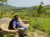 Dave sitting on a stone bench