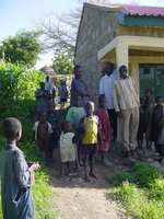 Boys and young men hanging around the side of a building