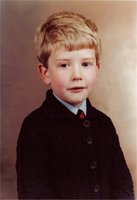 A young me in a cardigan and tie