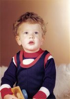 A young me with untidy hair and a fetching blue and red outfit