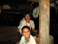 A woman and young boy in a wooden house.